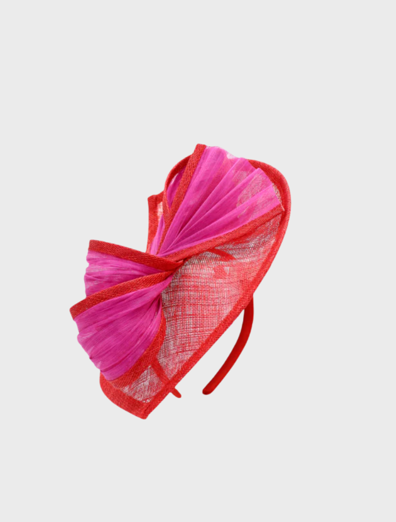 Vibrant red and pink fascinator adorned with floral details, suitable for weddings or upscale gatherings.
