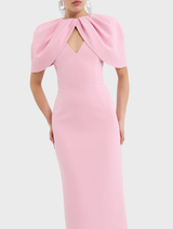 Soft light pink Xena gown draped elegantly, showcasing its beautiful design and luxurious fabric.