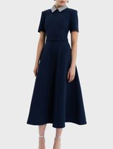 Navy Xena midi dress with short sleeves, combining comfort and elegance for a chic look in any setting.