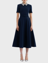Elegant navy midi dress with short sleeves, designed with a flattering silhouette for versatile styling options.