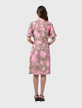 Midi-length Yala Dress with a vibrant leopard and floral print, stand collar, and puff sleeves with shirred cuffs.