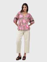 Yala Top features a bold leopard and floral print, V-neckline, and romantic puff sleeves with elasticated cuffs.