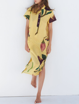 A vibrant yellow Blance shirt dress hanging on a rack, showcasing its casual style and button details.