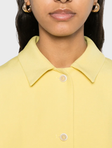 Citron yellow jacket with a layered style, front buttons, split cuffs, and two pockets, designed with long sleeves.