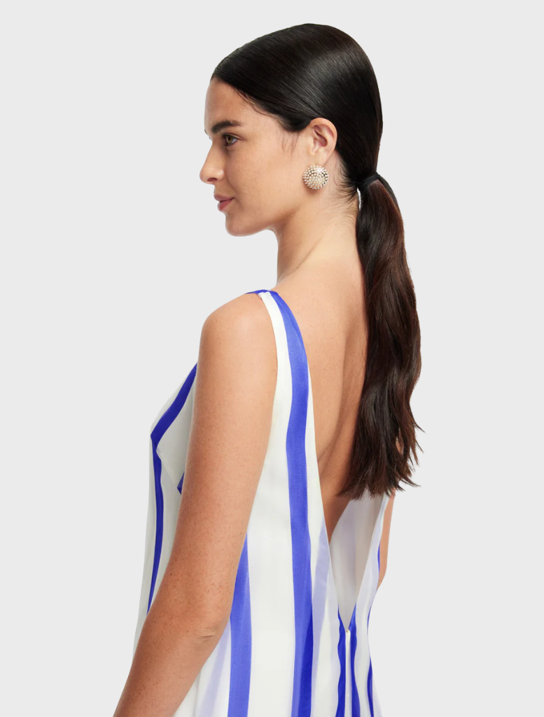 Yumei's navy gown features stripes and an open back, combining elegance and modern style for any event.