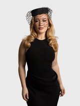 Black Zahra Pillbox Hat by Morgan & Taylor, featuring a structured design and bold veiling for a chic, formal look.
