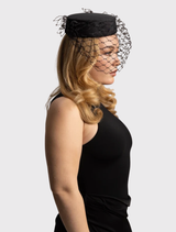 Elegant black Zahra Pillbox Hat with structured design and chic veiling, perfect for race day or formal events.