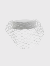 White pillbox hat by Morgan & Taylor, designed with a minimalist style and bold veiling for a refined event appearance.