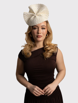 Ivory gold Zaria fascinator with wavy plate trim on a headband, ideal for race day or elegant occasions.
