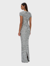 A silver Zayn gown elegantly draped, highlighting its luxurious texture and sophisticated silhouette.