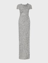 Silver Zayn gown hanging on a rack, featuring a sleek design and eye-catching shine.
