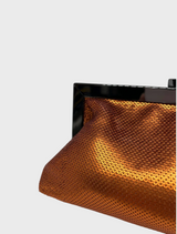An eye-catching Copper clutch bag adorned with a metallic clasp, ideal for accessorizing.