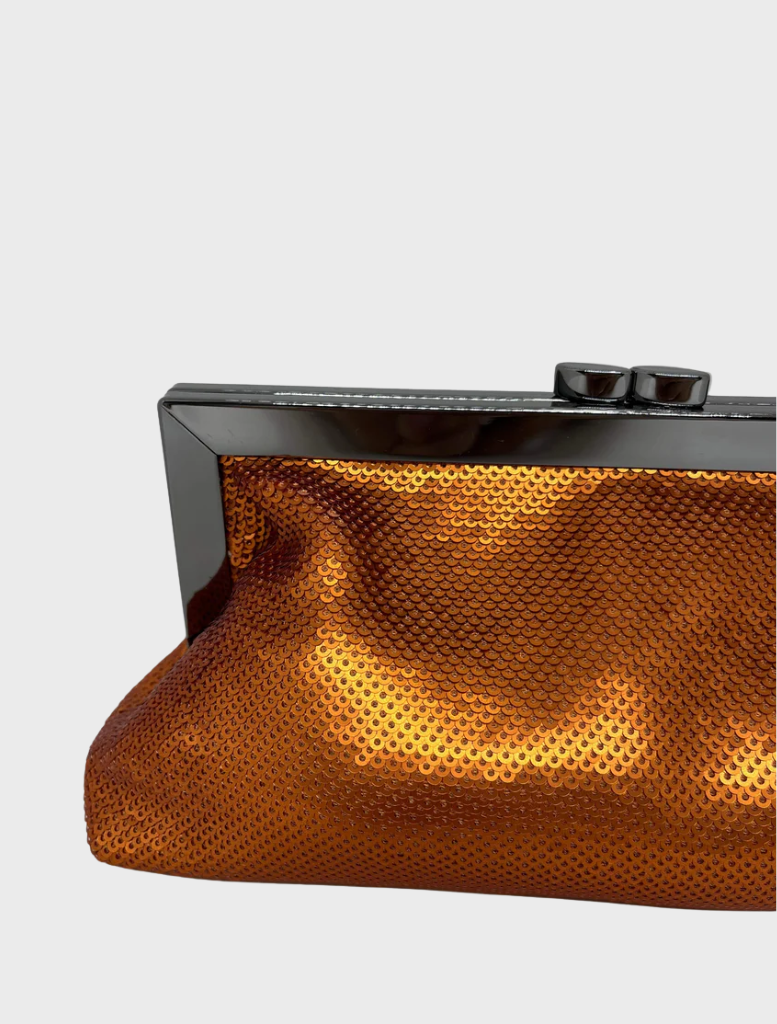 An elegant Copper clutch bag with a polished metal clasp, designed for chic outings.