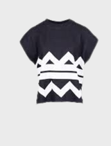 Black and ecru zigzag patterned top displayed on a hanger against a neutral background.