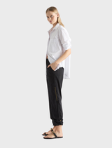 Black Zip Cargo pants displayed on a white background, featuring multiple pockets and a stylish, functional design.
