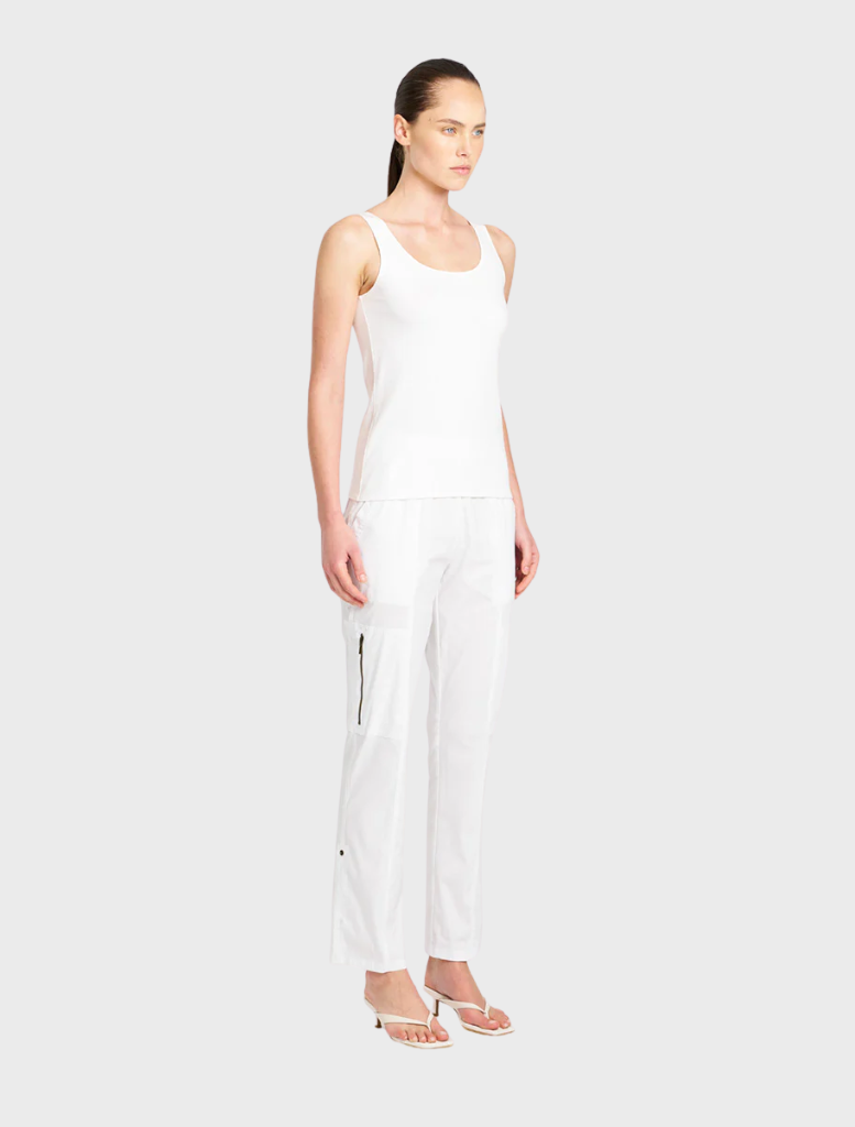 White Zip Cargo pants hanging, highlighting their stylish design and practical storage options.