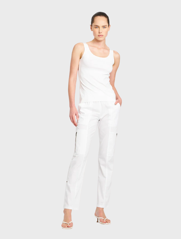 White Zip Cargo pants displayed on a hanger, showcasing a sleek design and functional pockets.