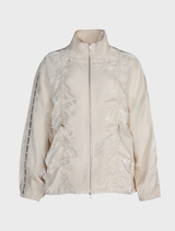 Cream jacket showcasing a bold shine, dual zipper for versatility, and adjustable toggles for a customized fit.