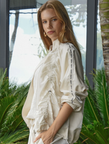 Cream jacket with a shiny finish, dual-ended zipper, and adjustable drawstring for a customizable fit.