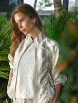 Cream jacket with liquid-like shine, dual-ended zipper, and adjustable drawstring for a customizable fit.