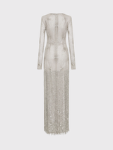 Elegant silver Ziva Gown with a column silhouette, round neckline, long sleeves, and detailed fringing along the skirt.